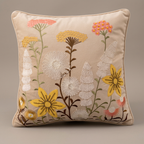 Beige floral cushion studio close-up showing embroidery and applique details